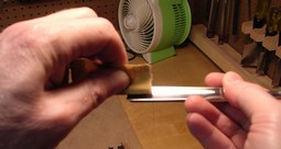 Flattening the inside of a gouge using 320 grit sandpaper rolled around a piece of dowel Flattening the inside of a gouge using 320 grit sandpaper rolled around a piece of dowel